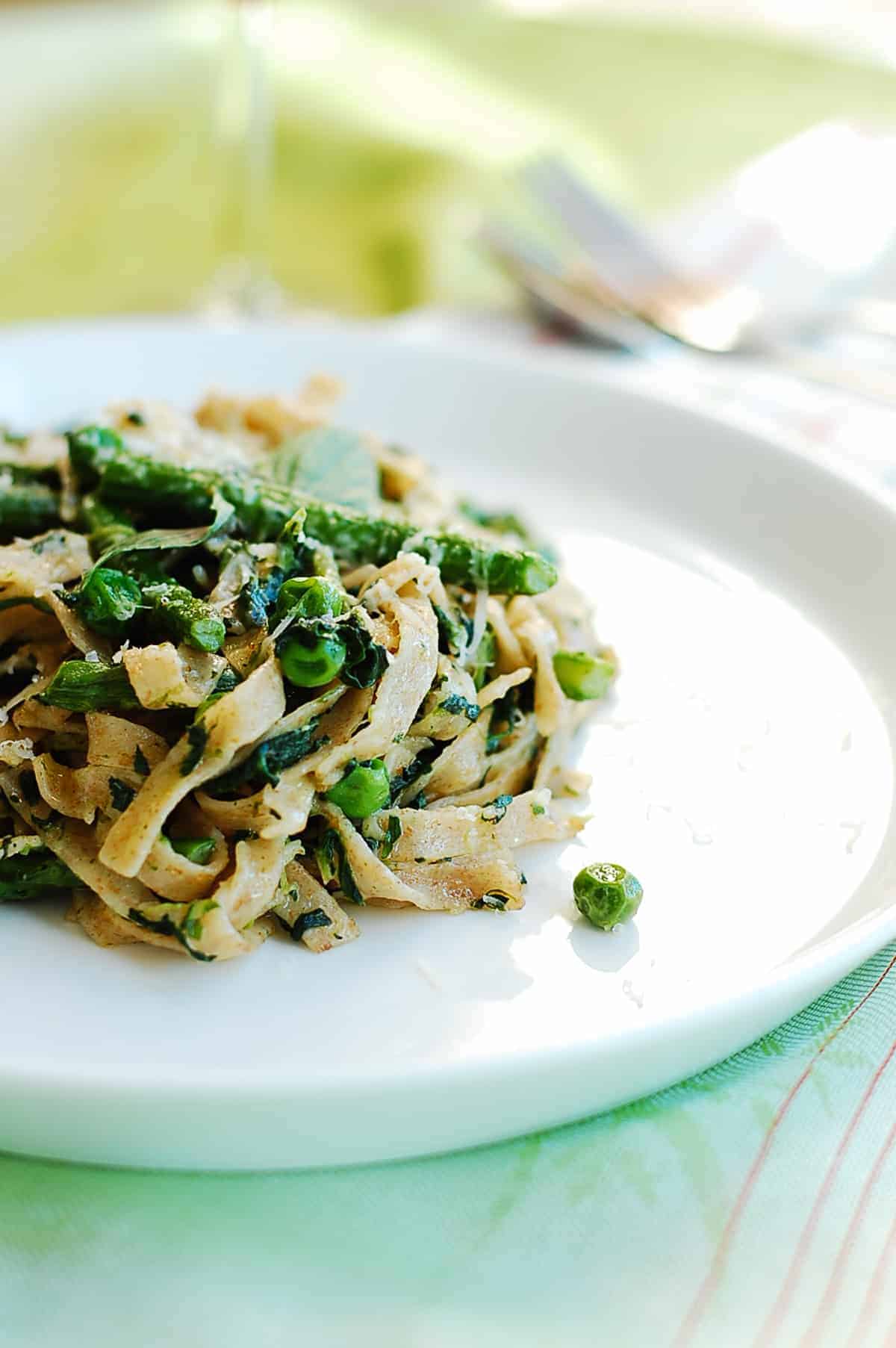 a serve of pasta tossed with greens