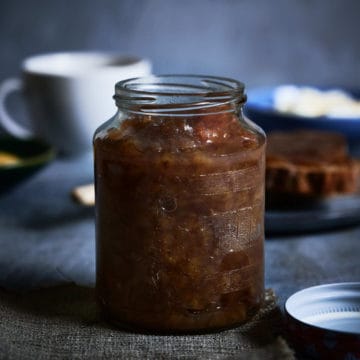 a jar of banana jam on a grey table