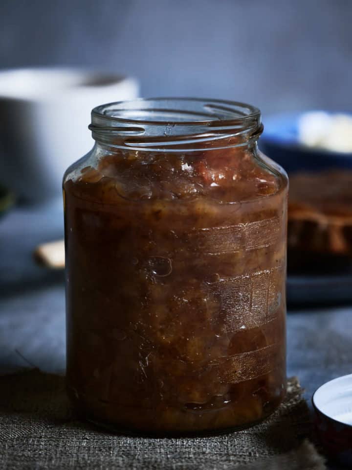 a jar of banana jam on a grey table