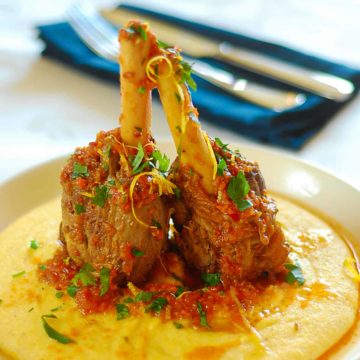 slow cooked lamb shanks served with polenta on a plate