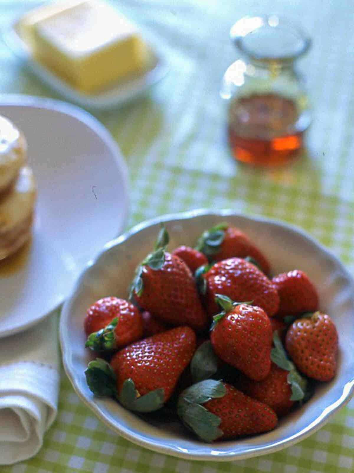 a bowl of strawberries on a table