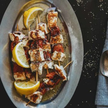 a plate filled with souvlaki made form swordfish