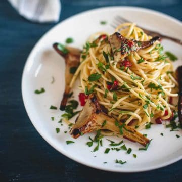 spaghetti served with artichokes on a plate