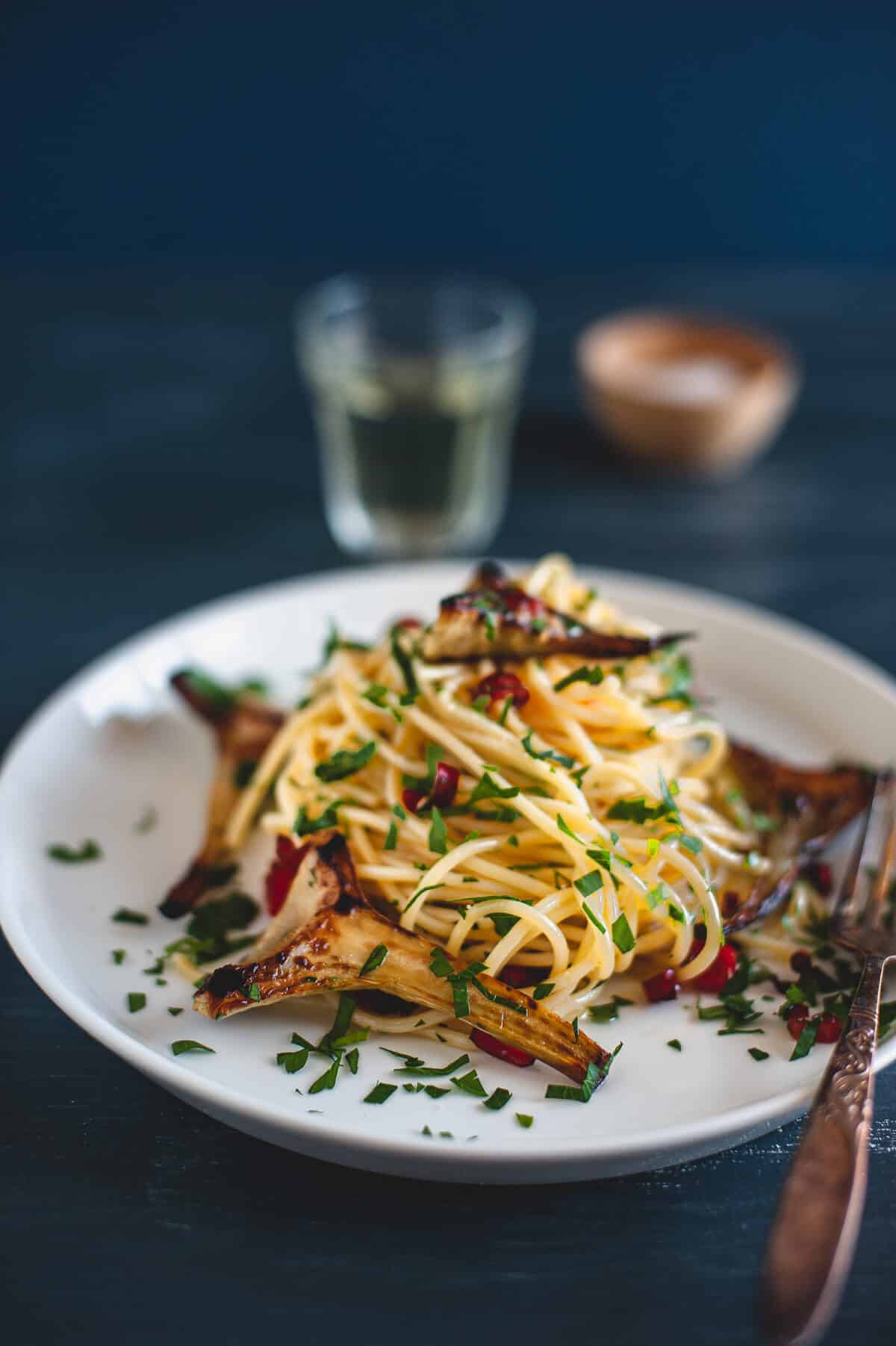 artichokes with spaghetti served on a plate