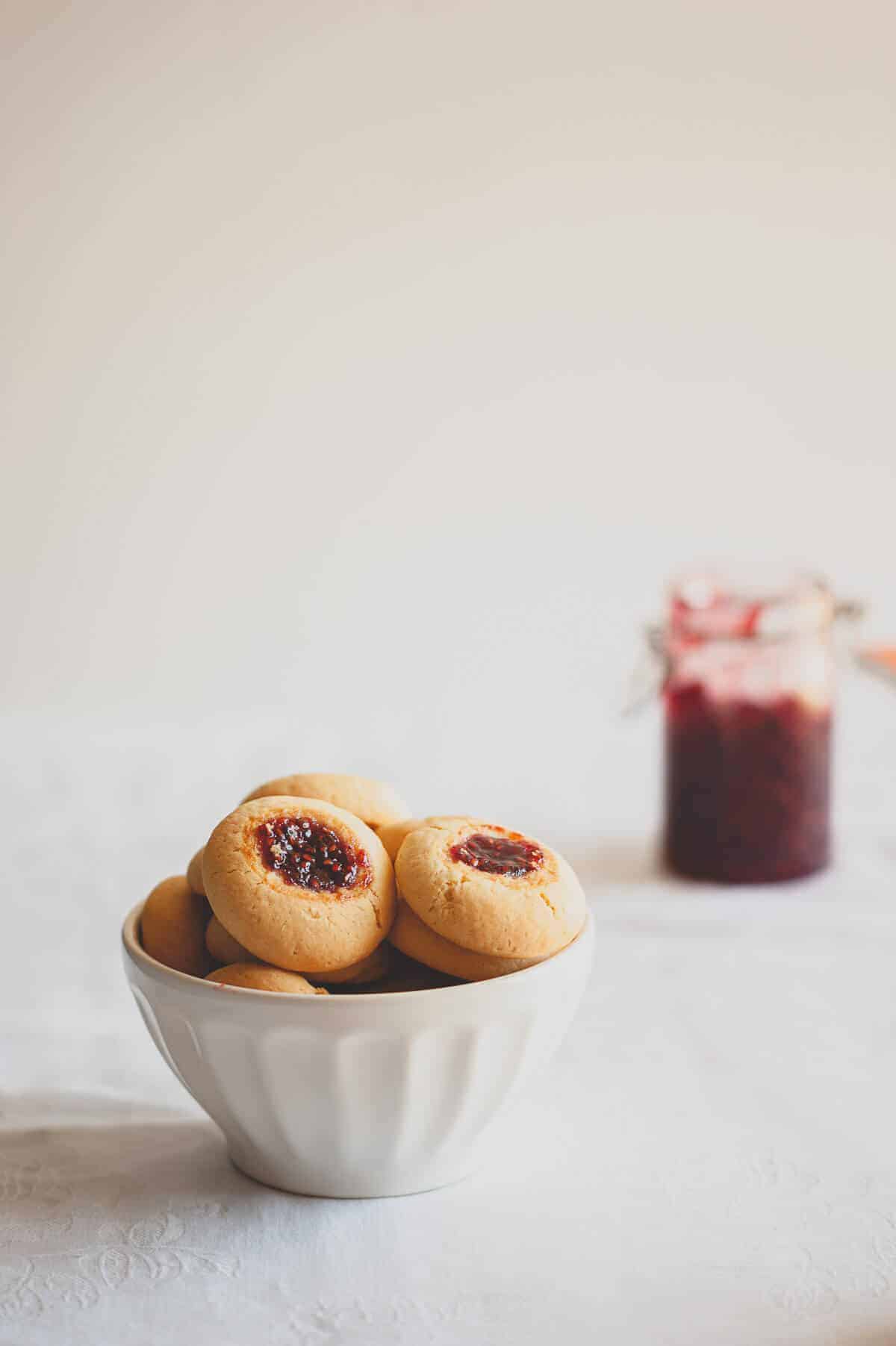 a bowl of biscuits that are filled with jam
