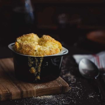 a cooked cheese soufflé's served on a board