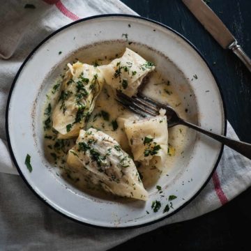 a white plate filled with cabbage rolls