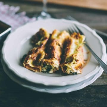 pasta tubes filled with ricotta and spinach served on a plate