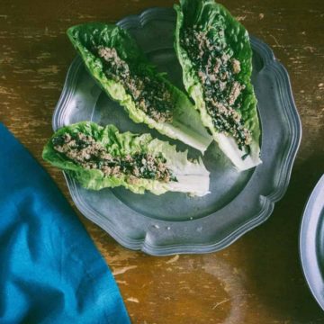 three Romaine lettuce leaves filled with an Asian mushroom mixture