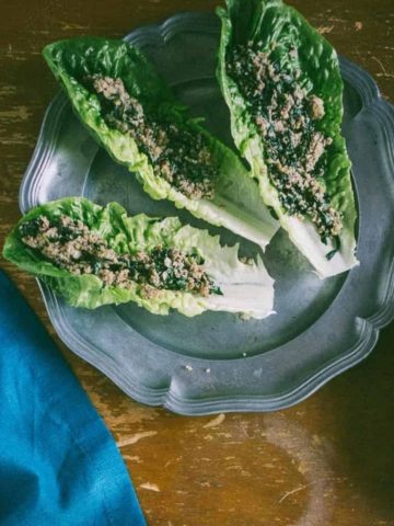 three Romaine lettuce leaves filled with an Asian mushroom mixture