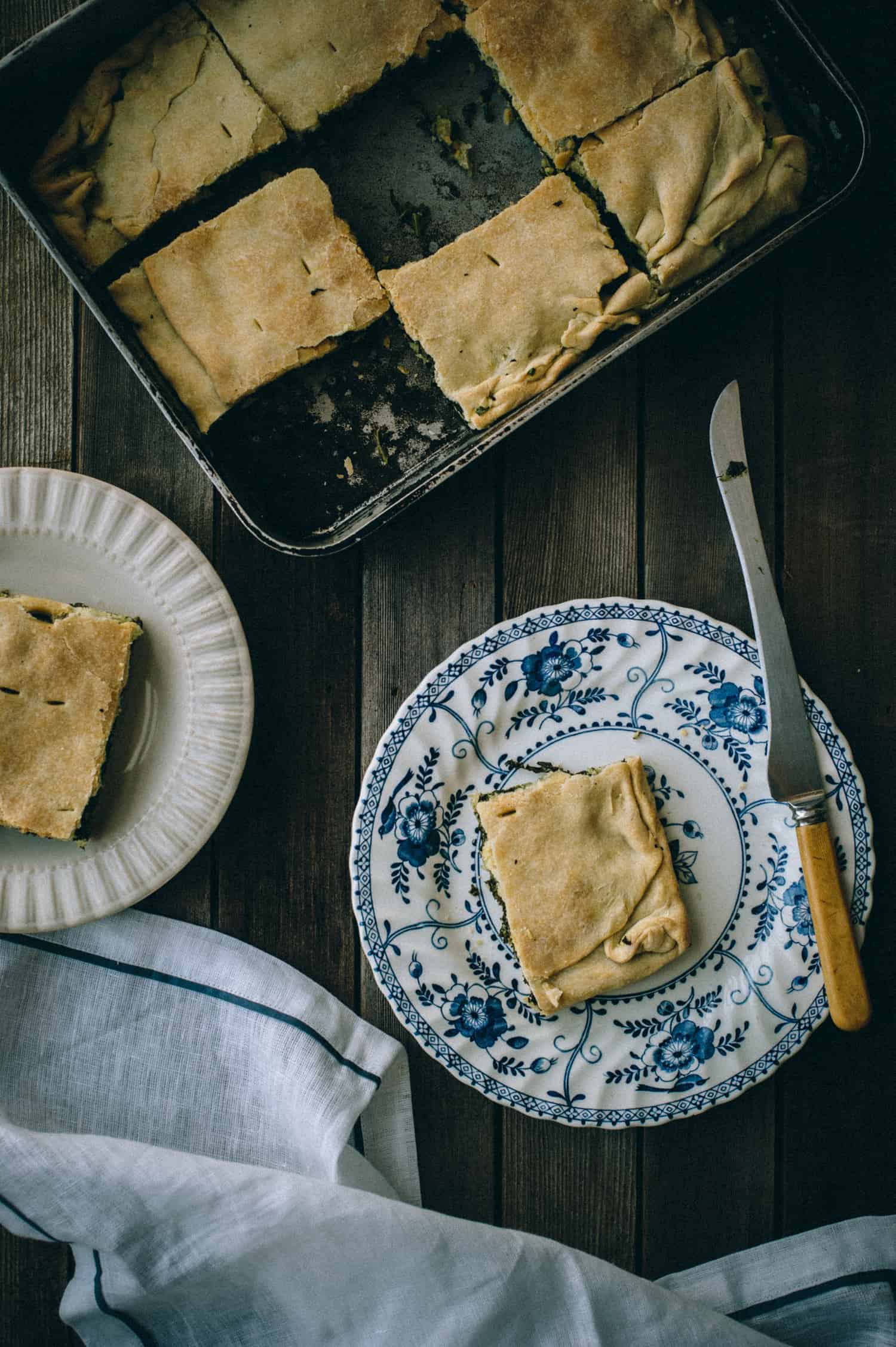 a slice of pie made with greens and feta