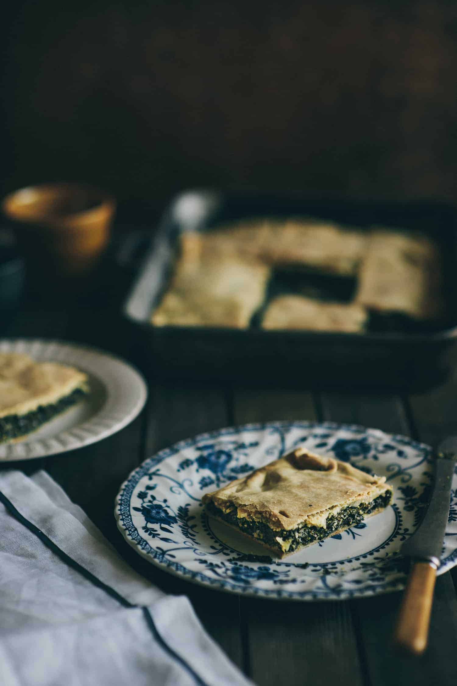 a slice of wild greens pie made with greens and feta