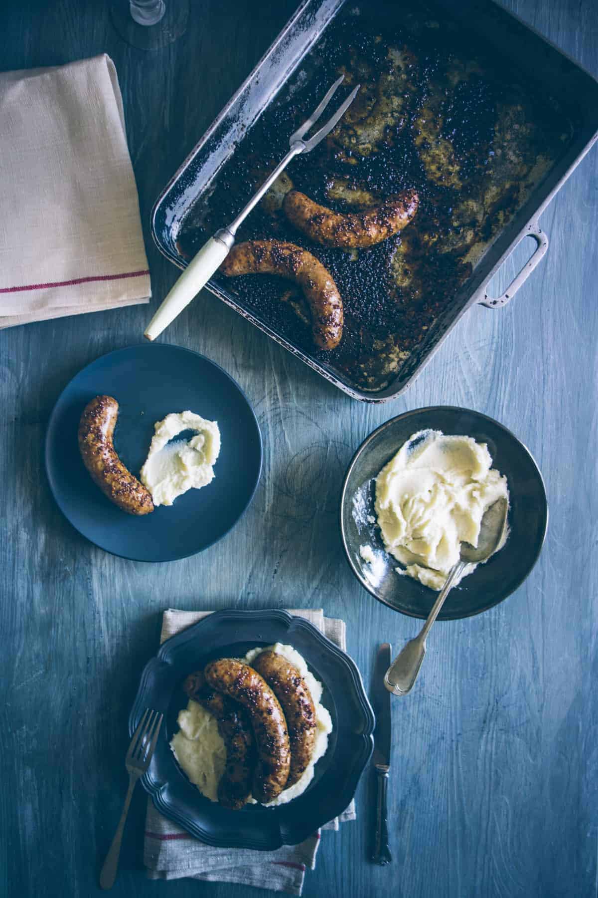 bangers and mash prepared and served on plates