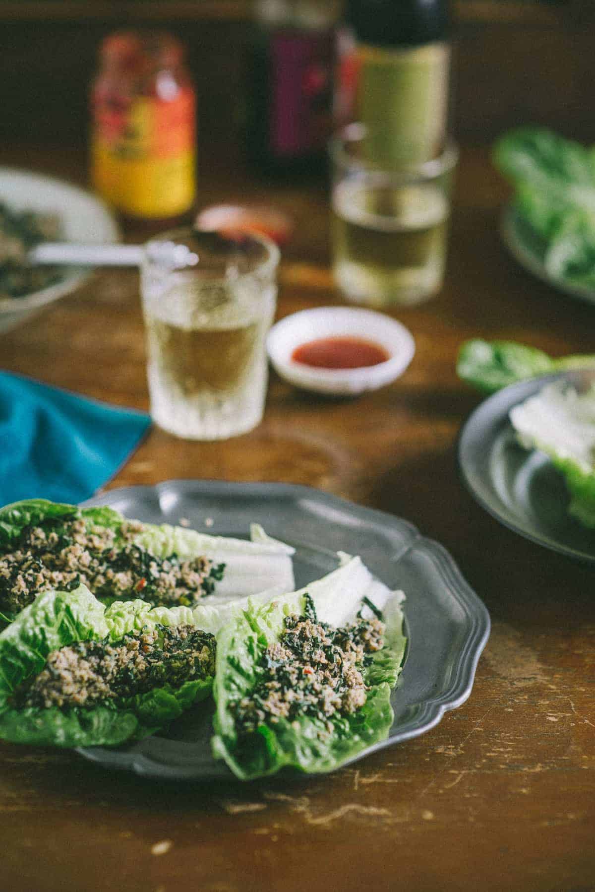 close up of 3 Romaine lettuce leaves filled with a cooked mixed mushroom mixture