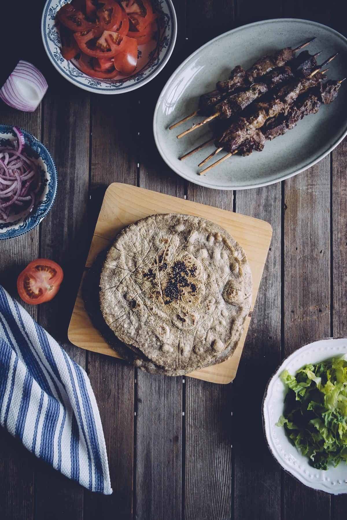 flatbread on table with a variety of fillings