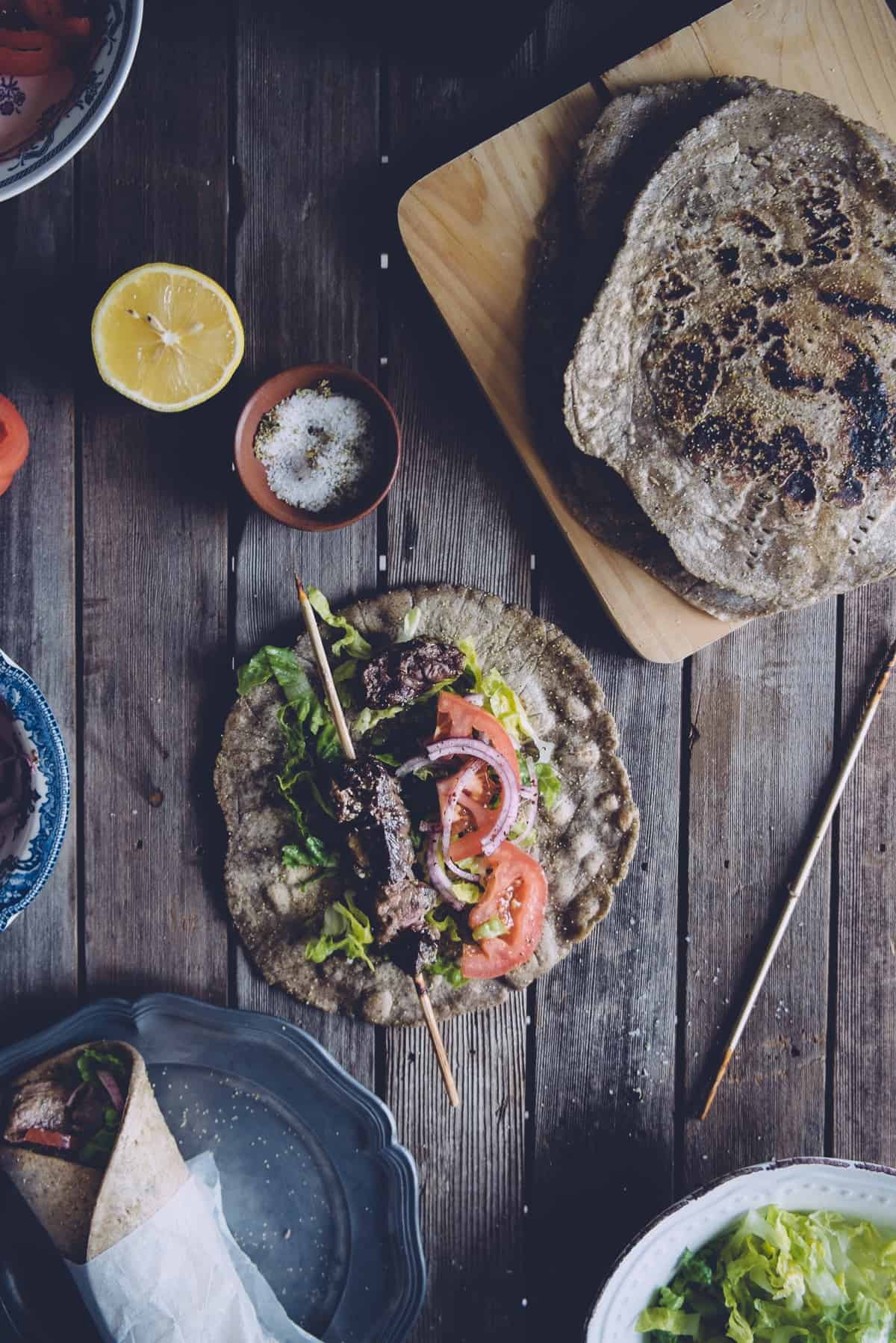 buckwheat pita bread filled with meat and salad on a plate