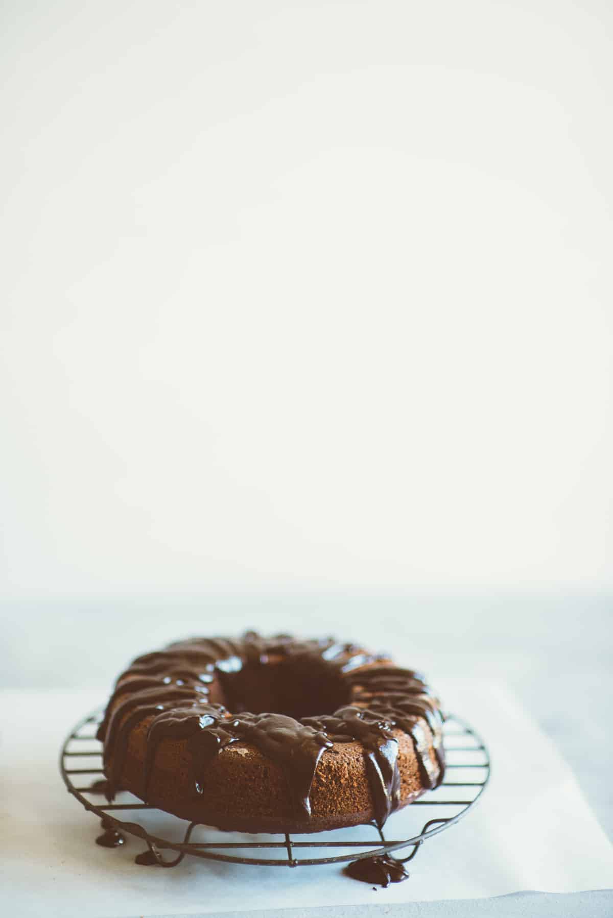 a chocolate and beetroot cake with icing on a wire rack