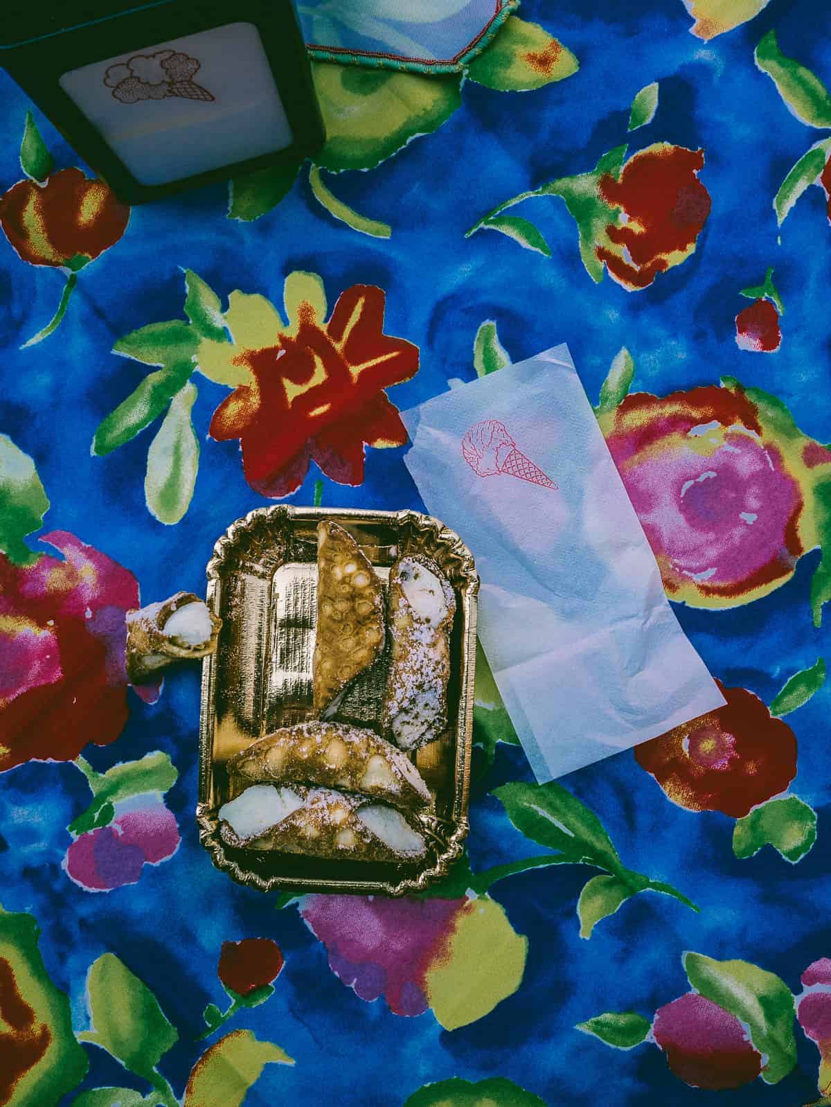 traditional cannoli served on colourful tablecloth in Taormina Sicily