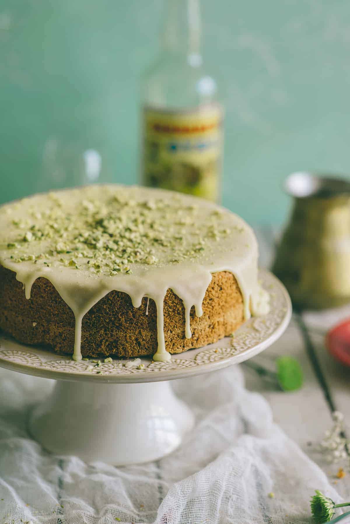 a cake flavoured with ouzo and pistachios. It is covered in a thick orange flavoured icing