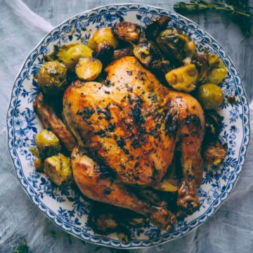 roast chicken served on a plate with a side of Brussels sprouts