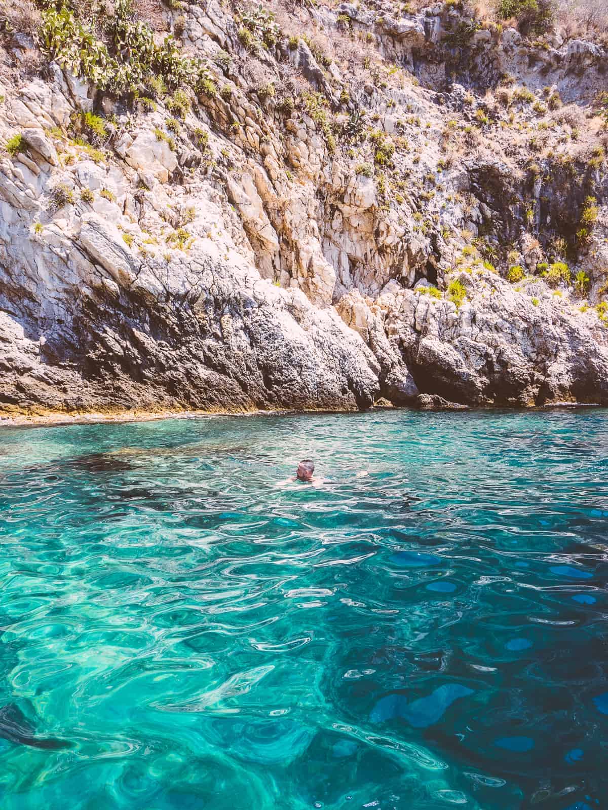 swimming in the 60 foot deep waters of Isola Bella Sicily Italy located near Mazzaro Beach