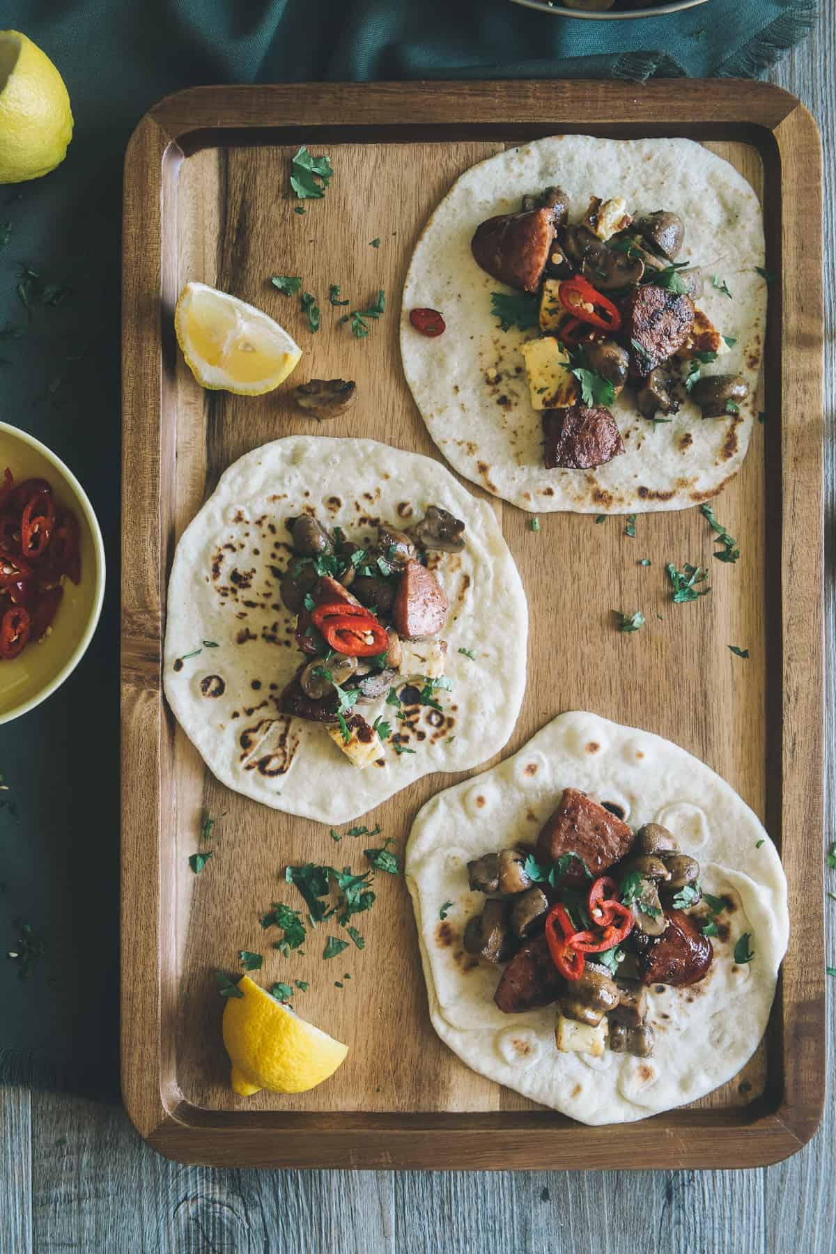 mushroom chorizo and halloumi tacos served on a board