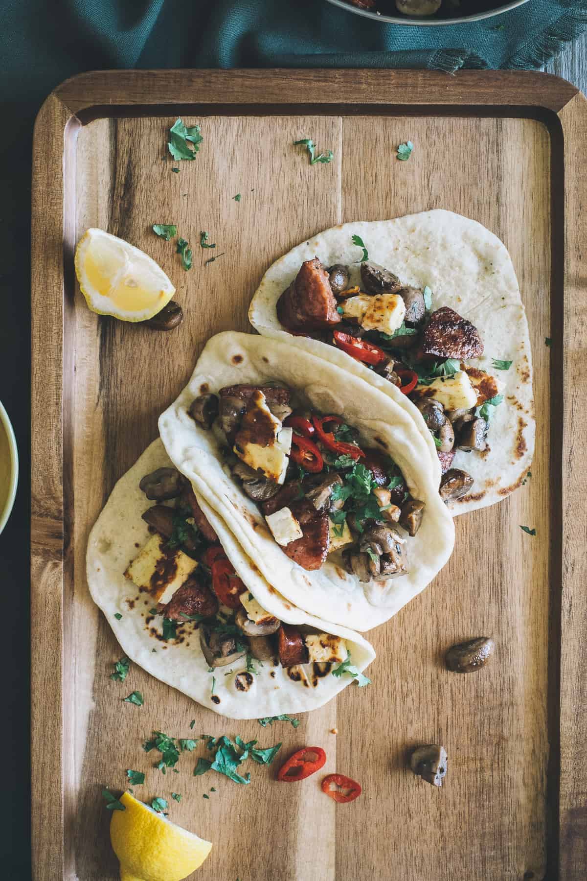 mushroom chorizo and halloumi tacos served on a board