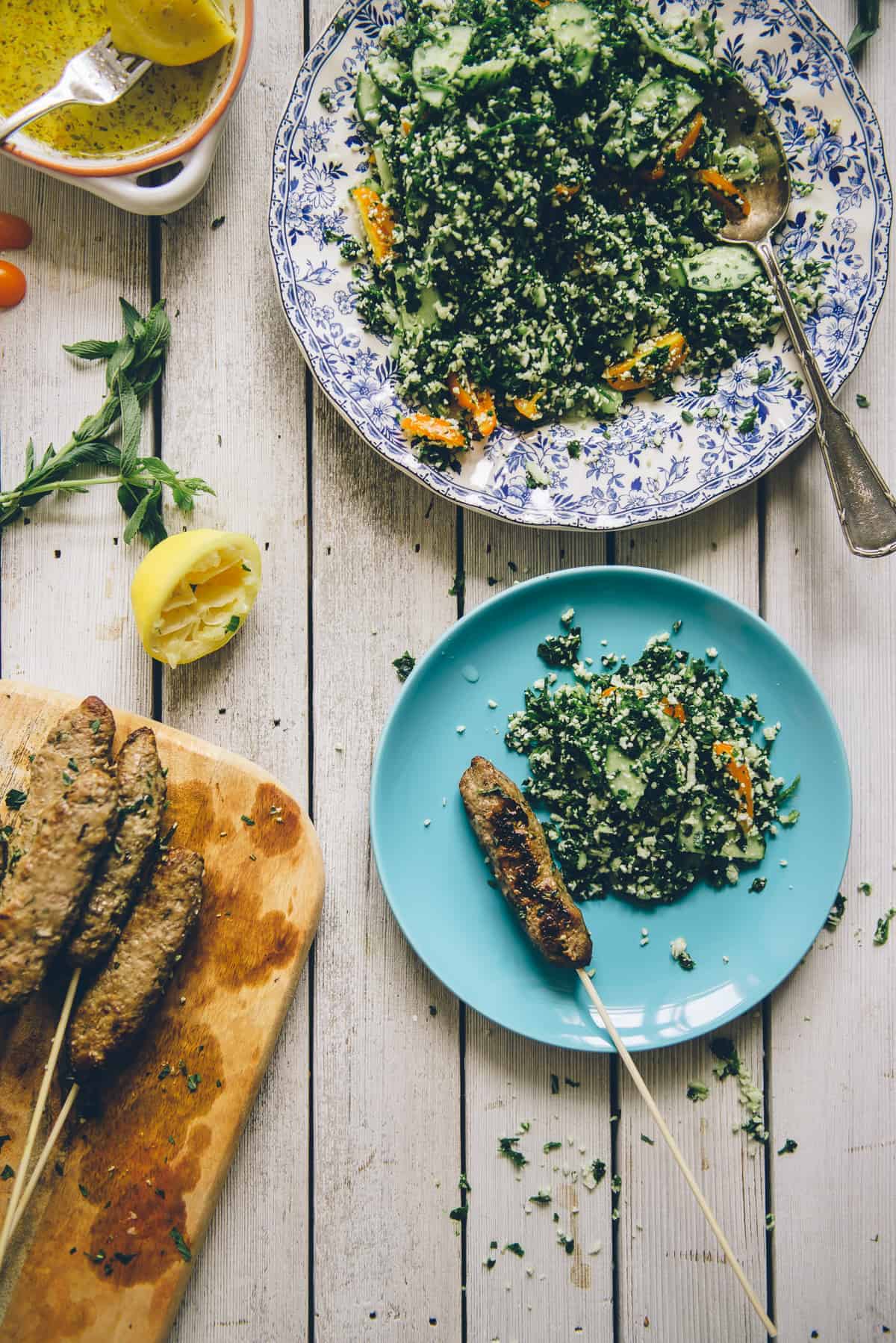 Middle Eastern beef kofta served with a grain free tabouli on a table