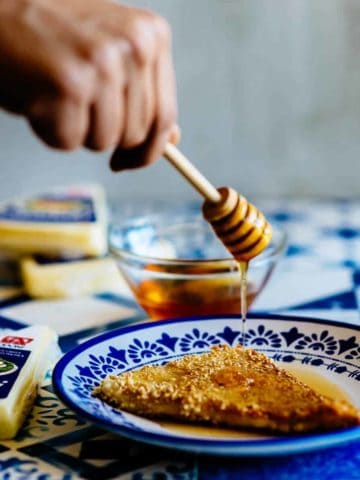 honey being drizzled over fried cheese