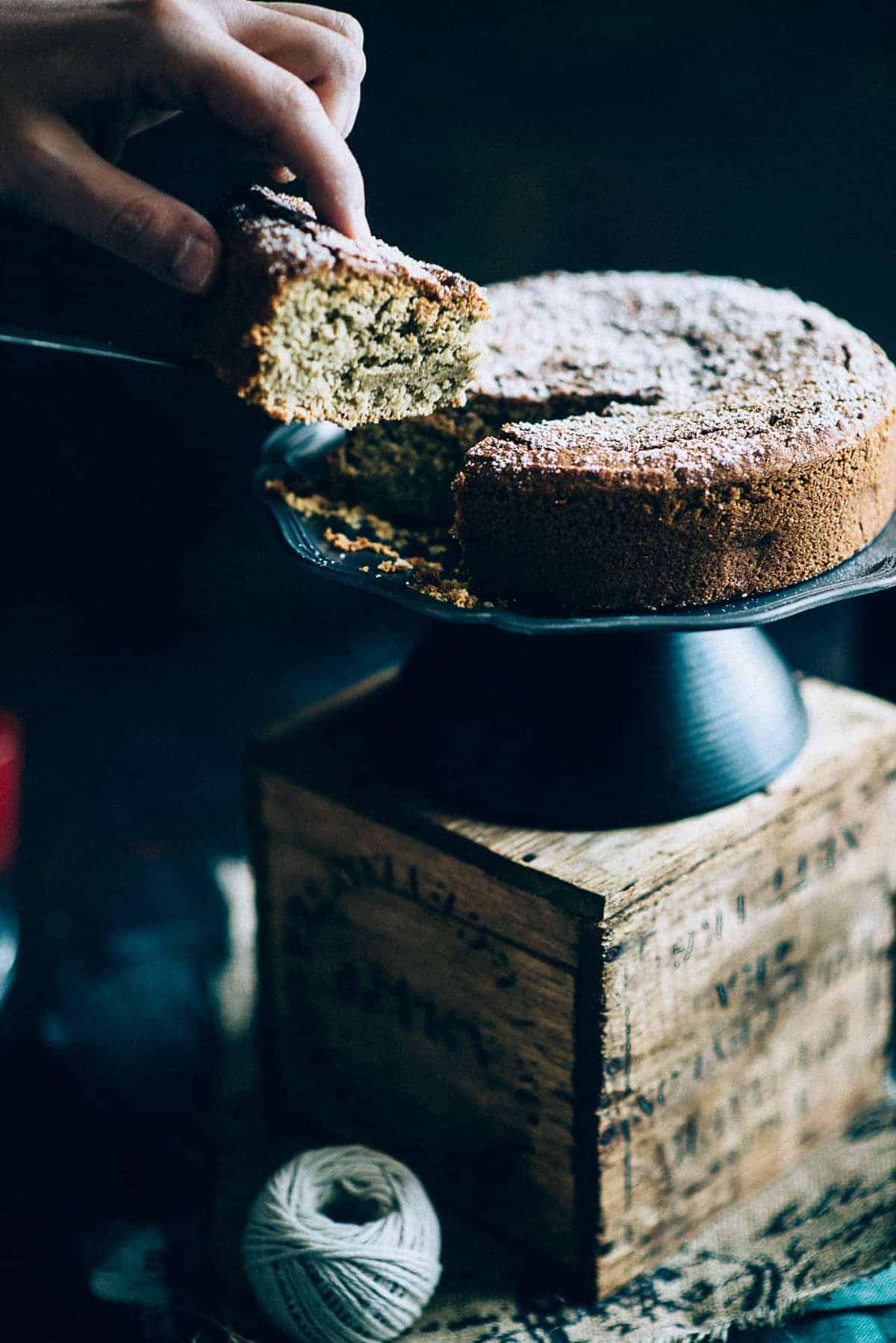 a slice of tahini cake being cut