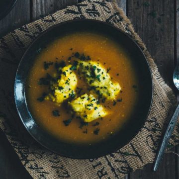 a bowl of soup with dumplings