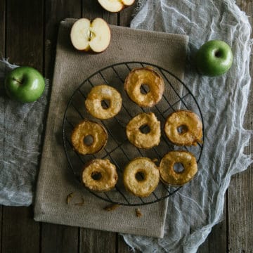 cooked apple fritters on a wire rack