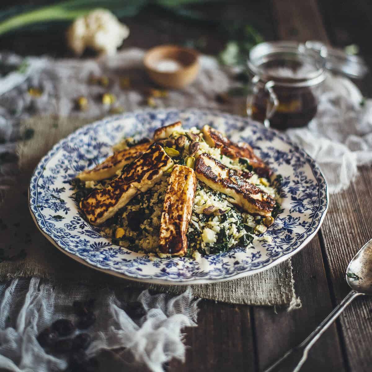 a salad made with cauliflower and halloumi served on a plate