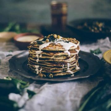 Middle Eastern inspired pancakes served on a plate drizzled with tahini