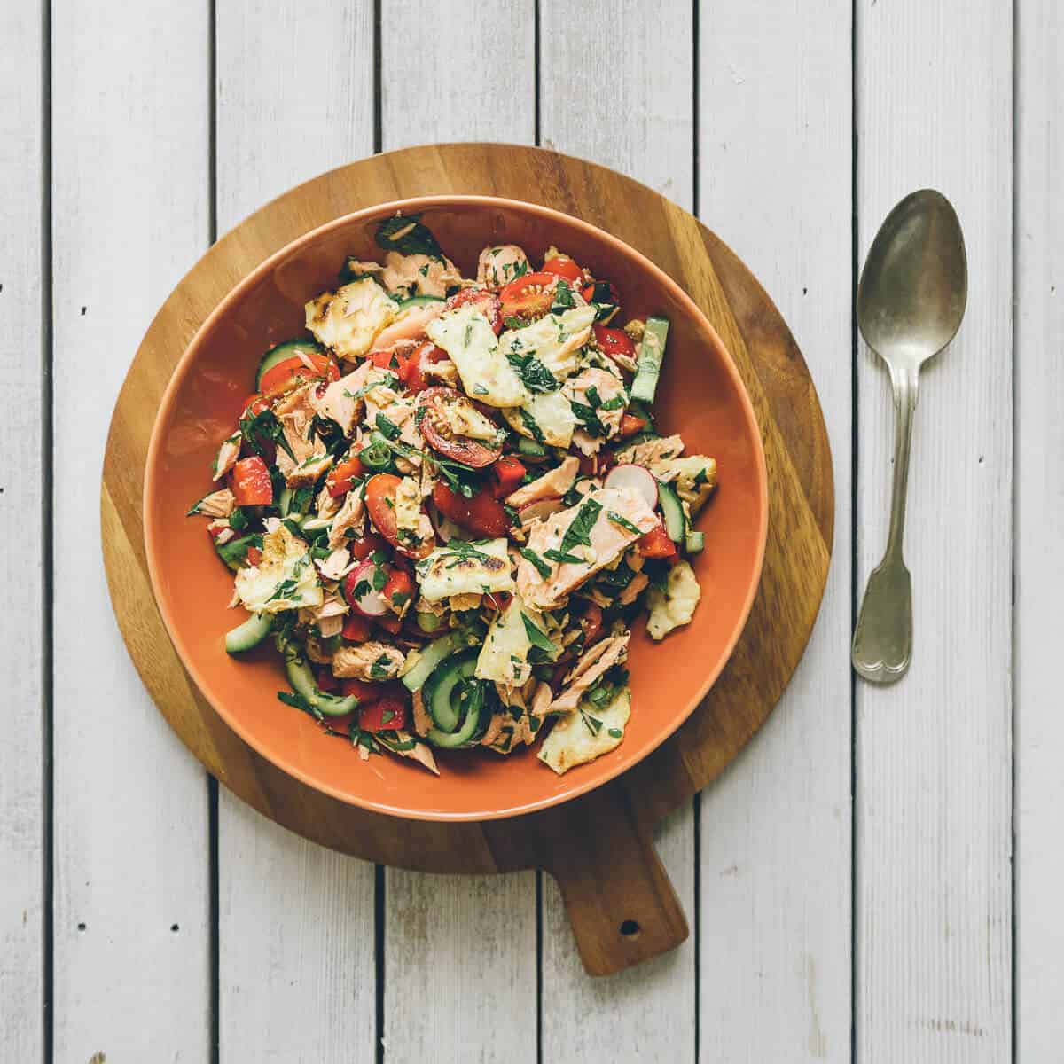 a salad served in an orange bowl