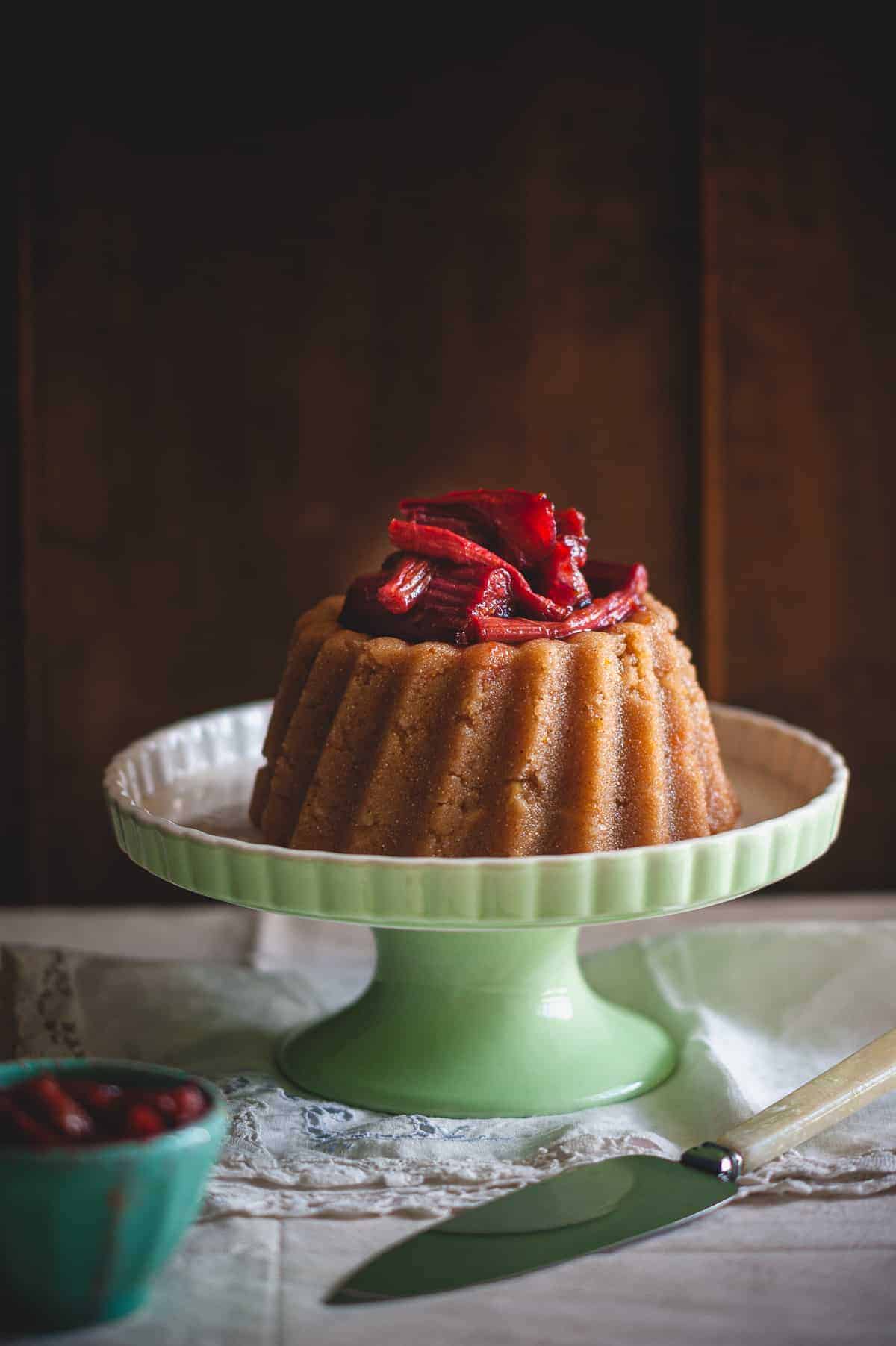 a Greek dessert known as halva on a cake stand served with a rhubarb compote