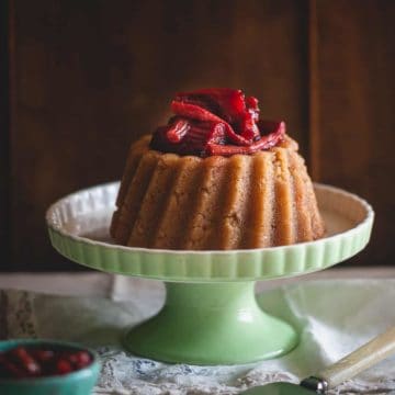 a Greek dessert known as halva on a cake stand served with a rhubarb compote