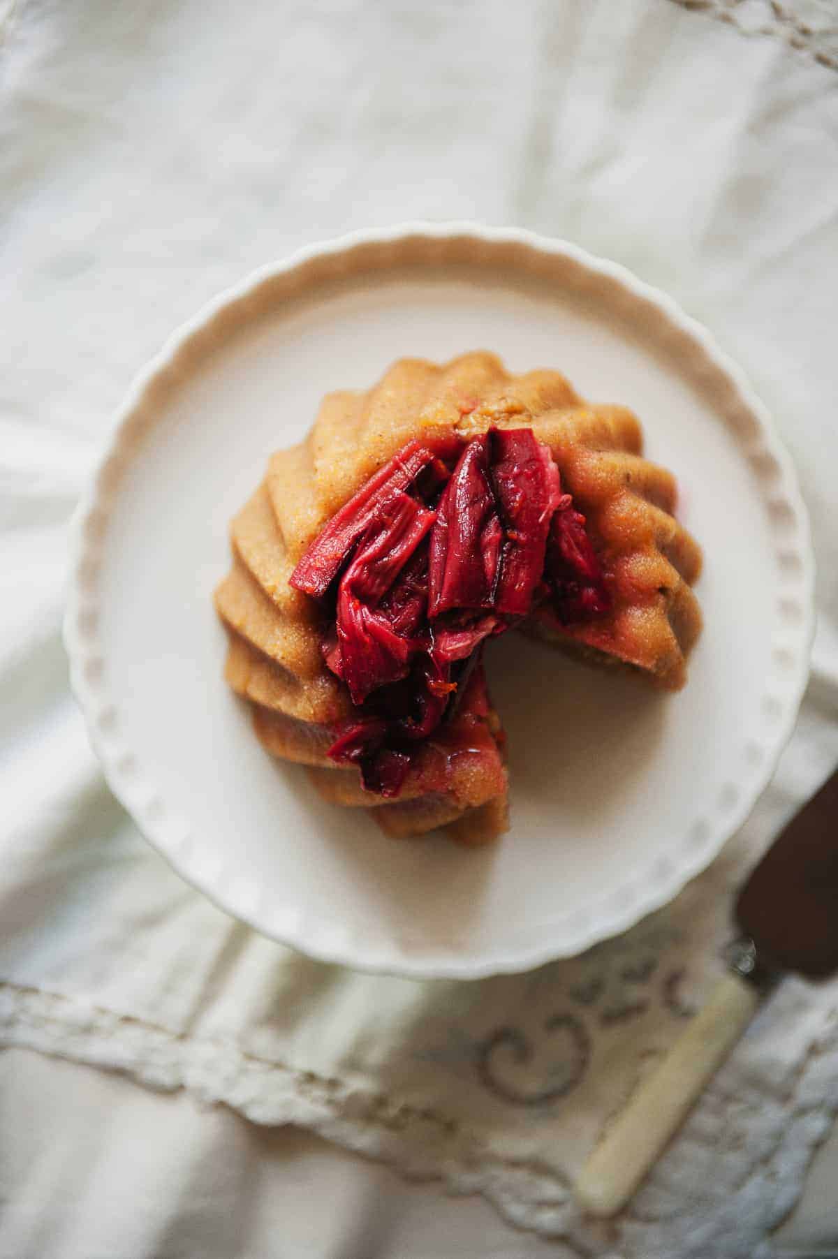 a birds eye view a Greek dessert known as halva on a cake stand served with a rhubarb compote