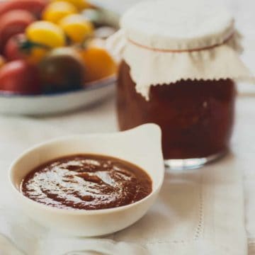 a small ramekin filled with homemade tomato ketchup on a table