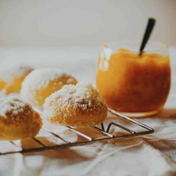 doughnuts filled with jam on a cooling rack