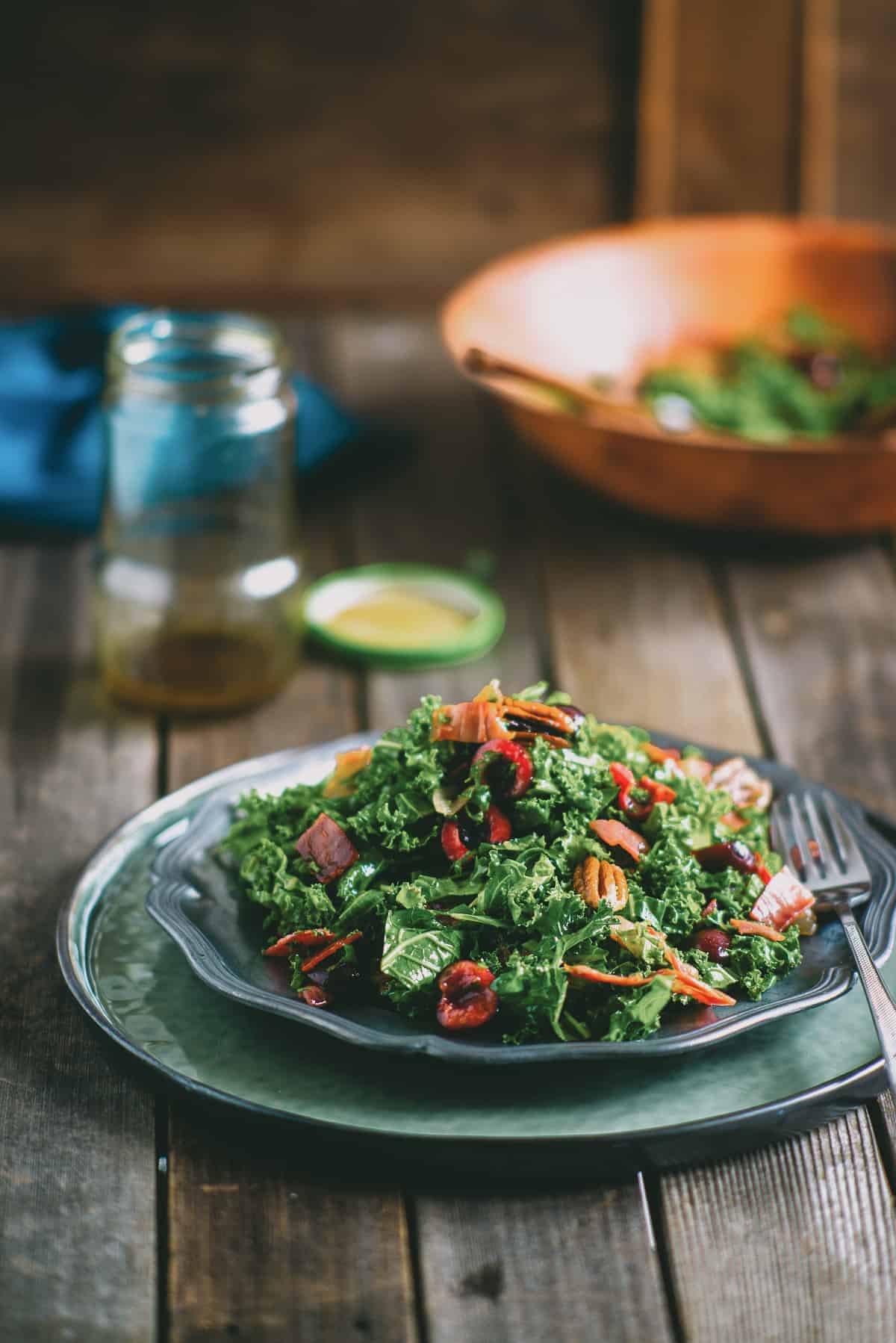 a salad made with kale served on a plate on a wooden table