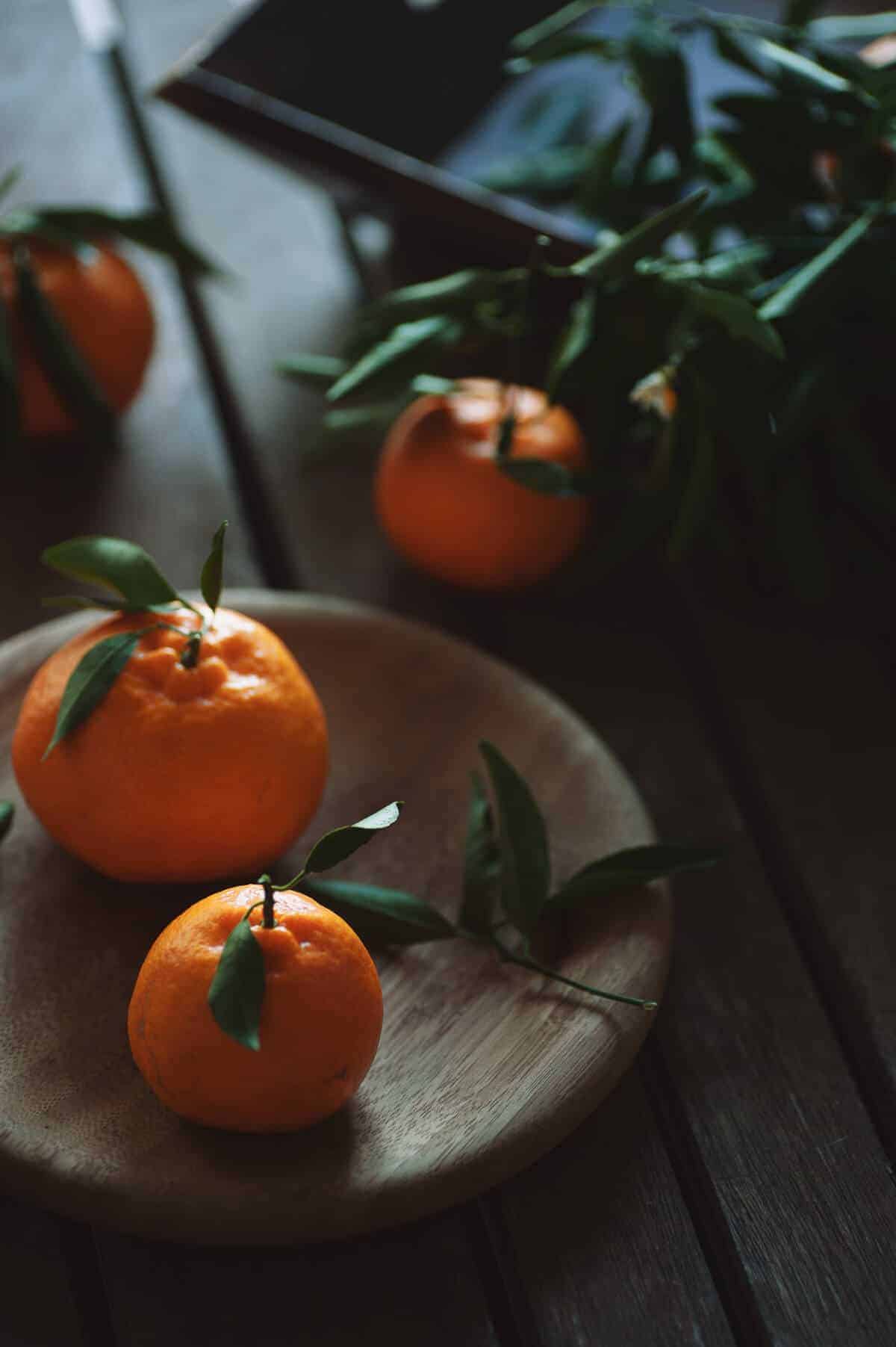 four mandarins on a wooden table