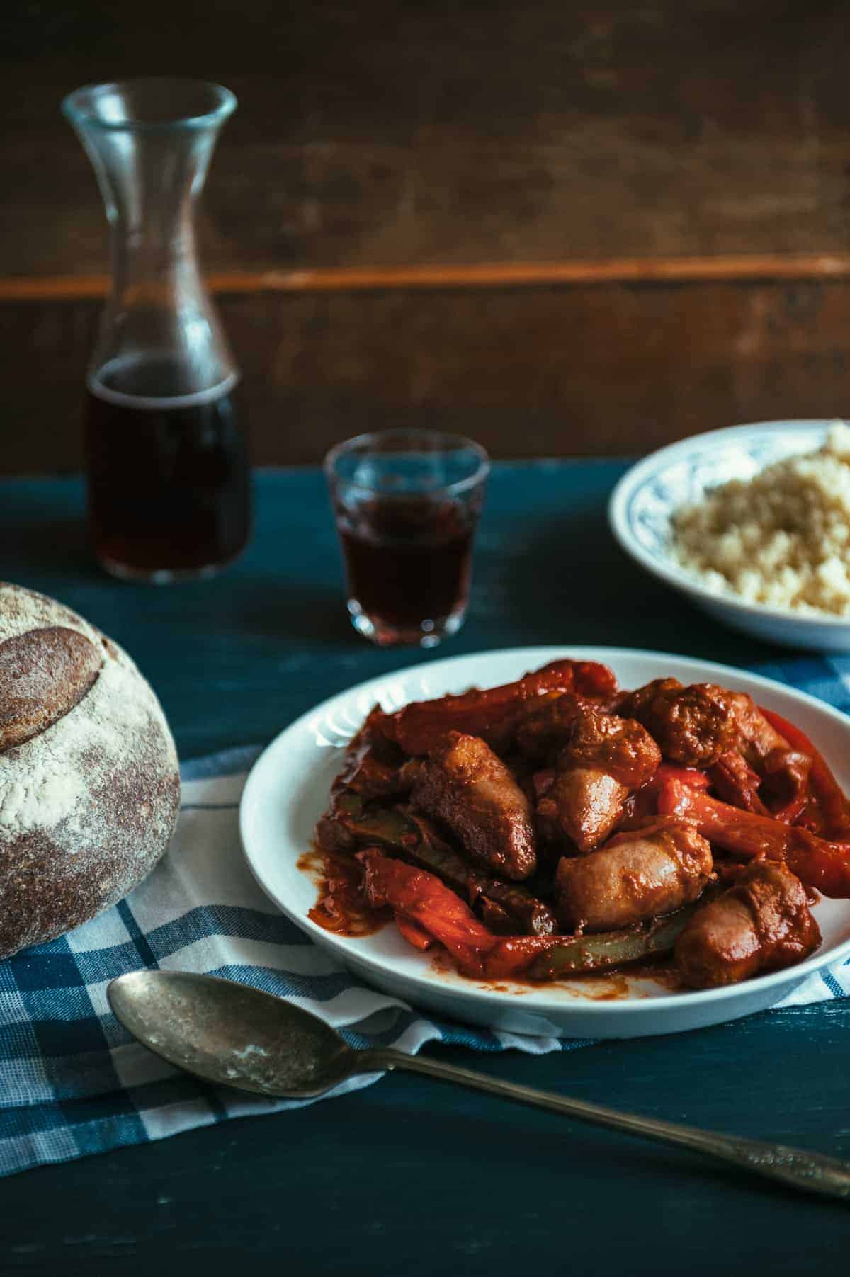 a plate filled with sausages and peppers cooked in a tomato sauce