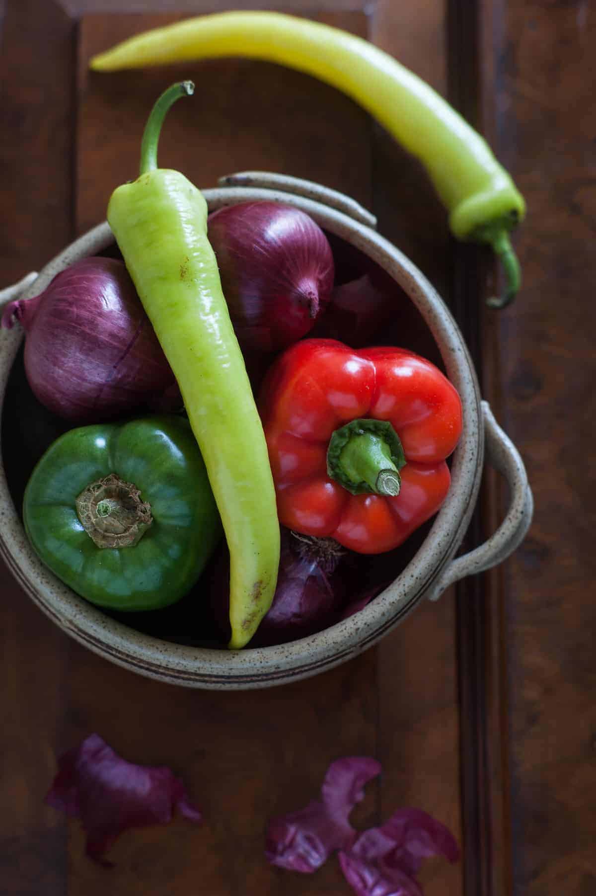 a bowl filled with a variety of peppers