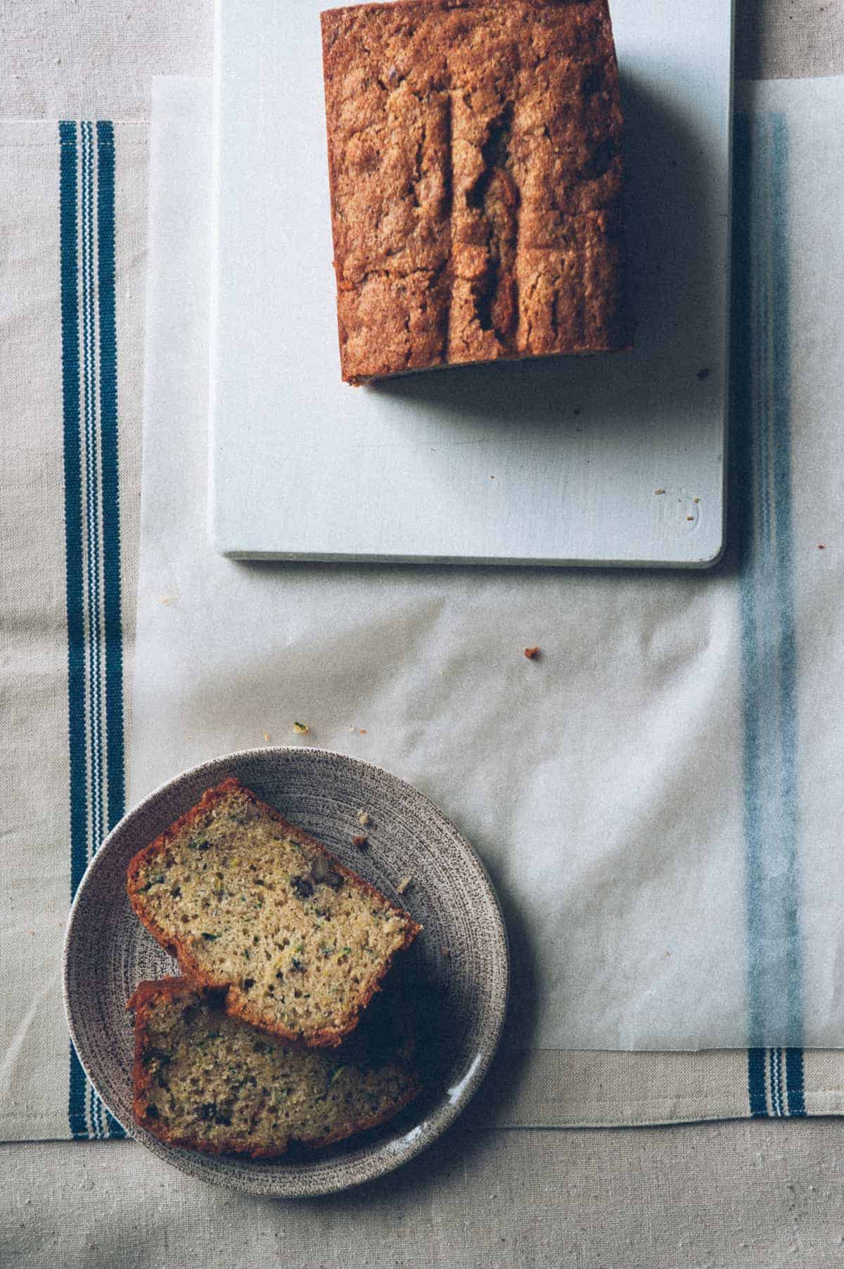 a birds eye view of a zucchini bread sliced on a plate