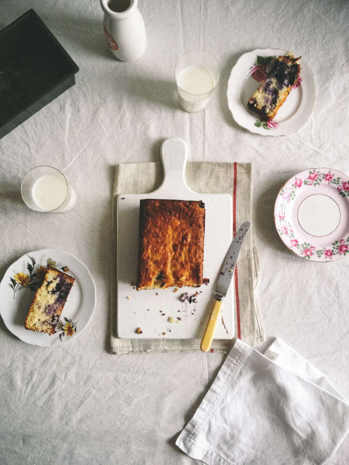 a to[pp down view of a cake on table with plates and slices of cake