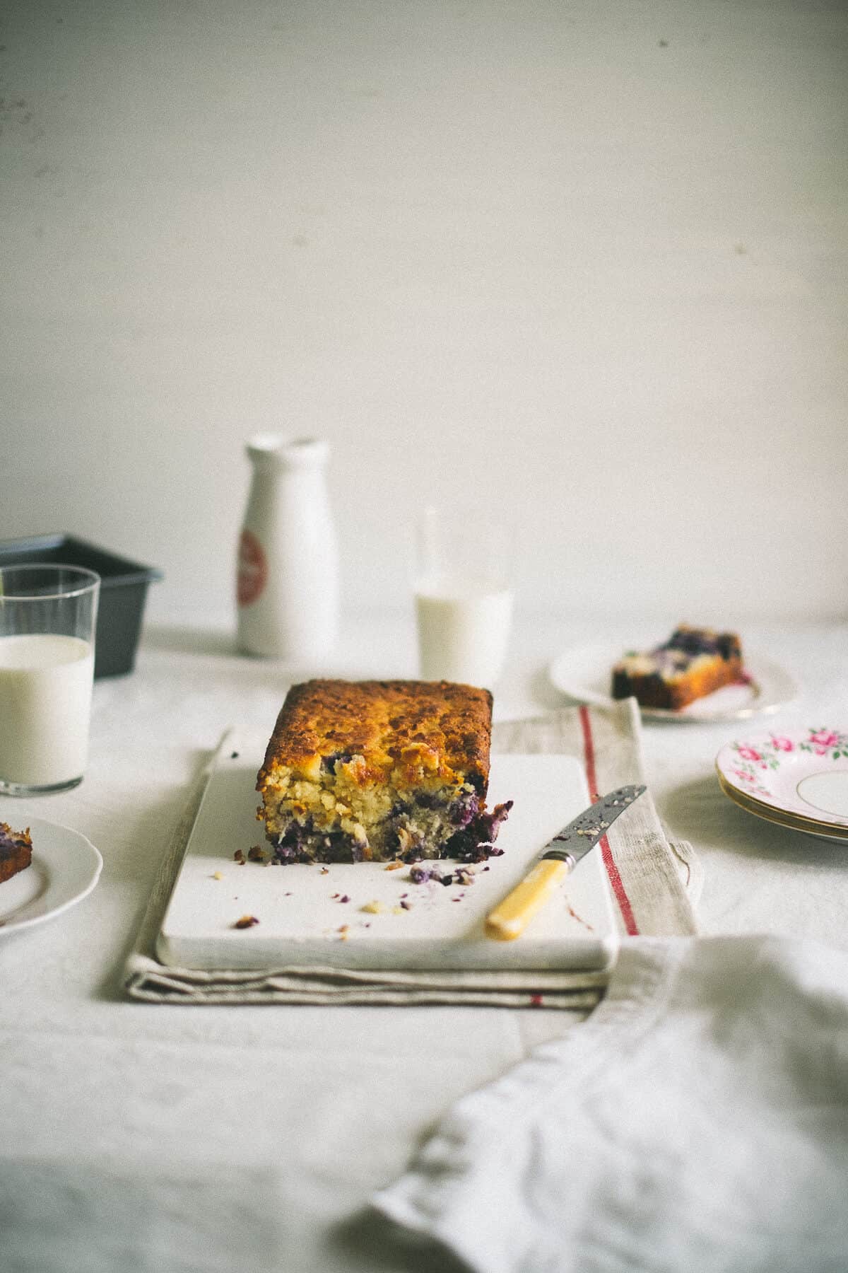 a sliced cake bread on a white board on a table