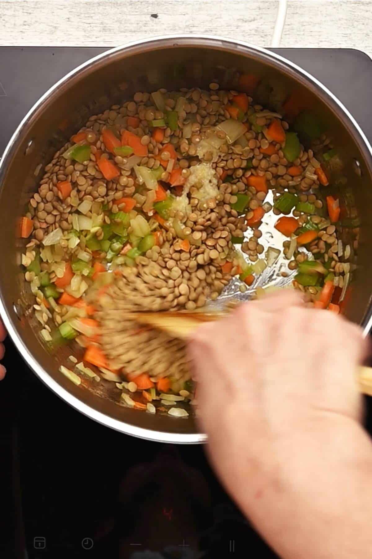 sautéing carrots, onion, celery and lentils in a large soup pot