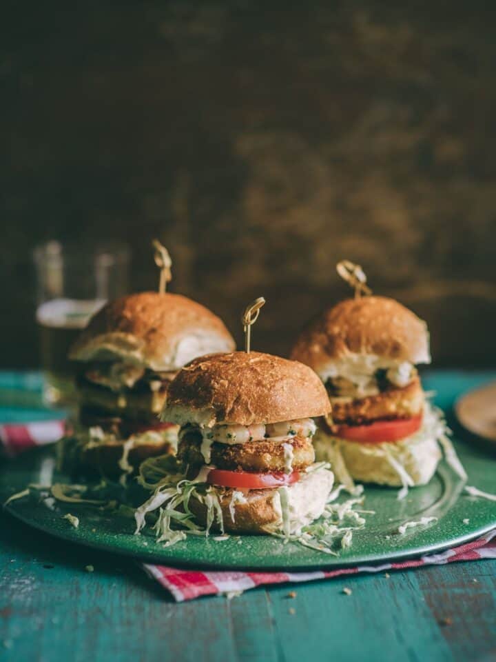 three burgers on a green plate
