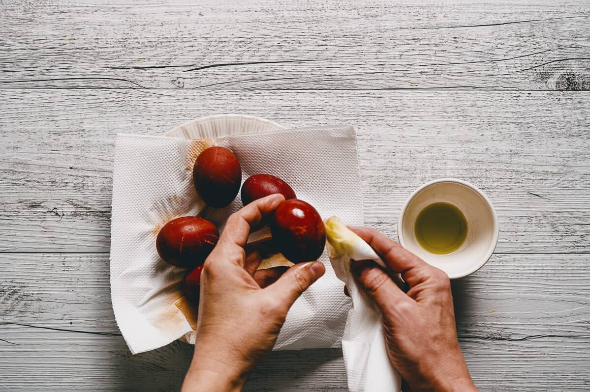 polishing dyed red eggs with olive oil